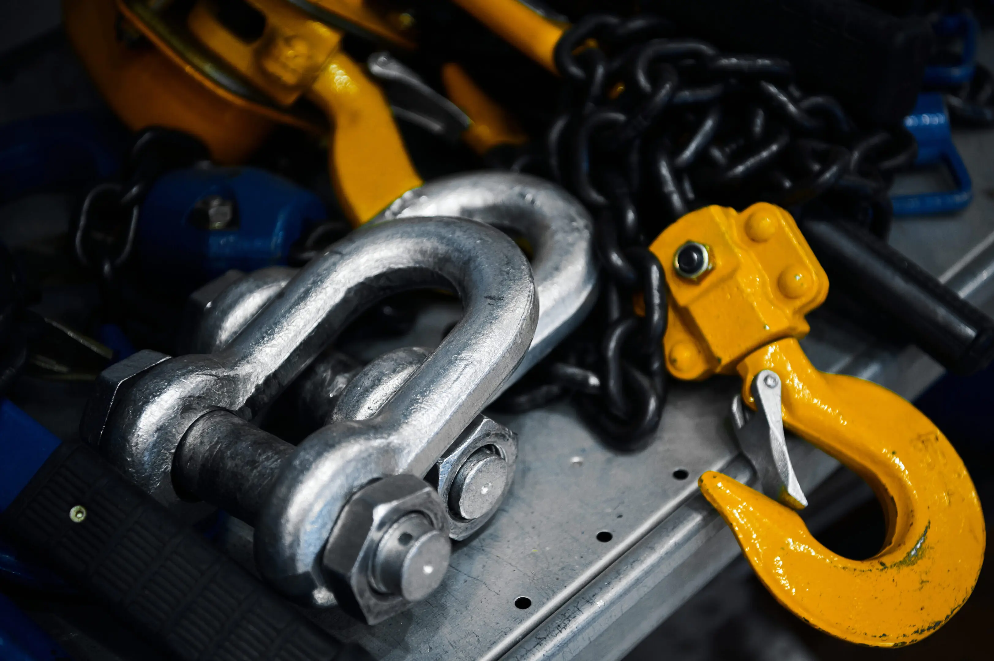 Heavy duty rigging hook and shackle used for lifting and securing loads in industrial applications.