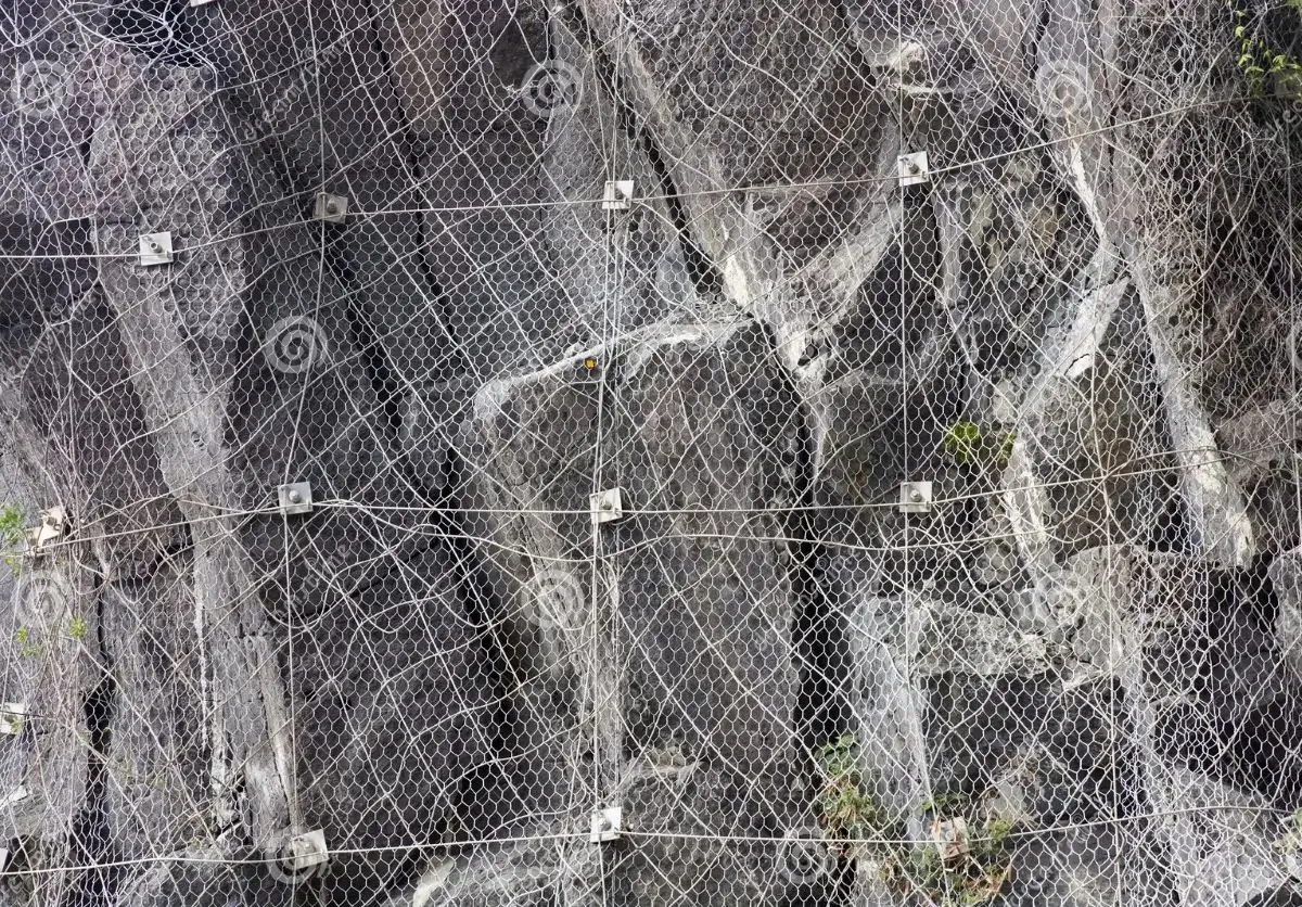 Steel wire mesh rockfall protection installed on rocky slope for erosion control and safety